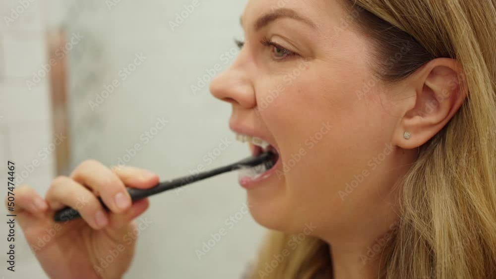 young woman brushing her teeth close-up young woman brushing her teeth close-up