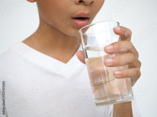 Child drinks water. health concept. closeup photo, blurred.
