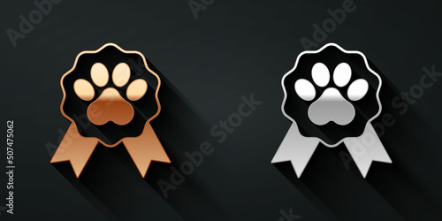 Gold and silver Pet award symbol icon isolated on black background. Badge with dog or cat paw print and ribbons. Medal for animal. Long shadow style. Vector