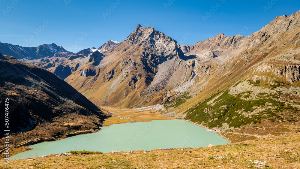 View on the largest lake in the Ötztal Alps, the beautiful Lake Rifflsee. It is located close to the Kaunergrat Nature Park above the Pitztal Valley, surrounded by Ötztal Alps and Kaunergrat peaks.
