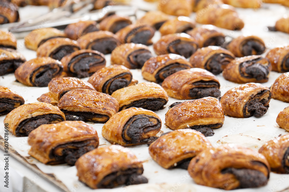 Tasty freshly baked buns on the bakery counter Tasty freshly baked buns on the bakery counter