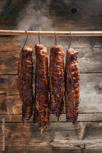 Tasty meats. Traditionally smoked meats pork ham. Traditional method of smoking meat in smoke
