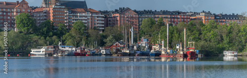 Photography Panorama view with boats at a wharf at the district Södermalm a sunny day in Sto