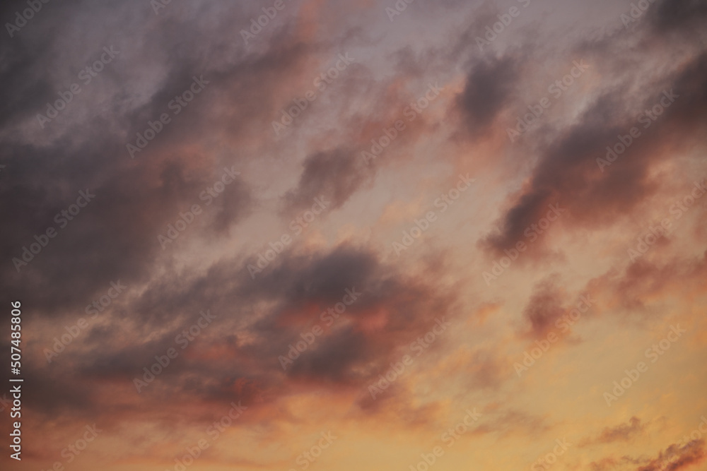 Full frame of beautiful sky with clouds at sunset in warm colors.