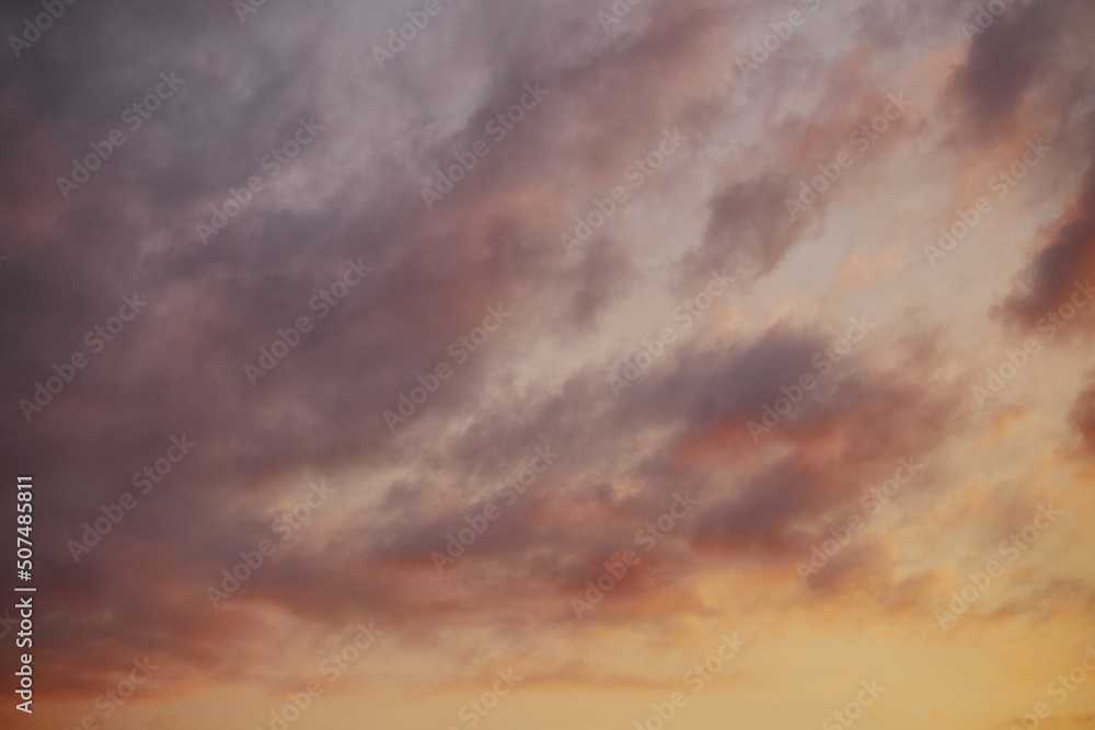 Full frame of beautiful sky with clouds at sunset in warm colors.