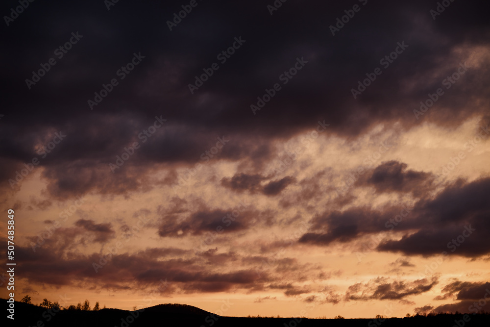 Silhouette of mountains against the backdrop of a sunset sky with bright clouds. Silhouette of mountains against the backdrop of a sunset sky with bright clouds.