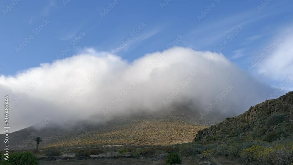 Clouds running over volcano, Lanzarote island Clouds running over volcano, Lanzarote island