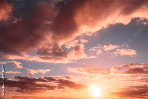 Sunshine in sunrise bright dramatic sky. Scenic colorful sky at dawn. Sunset sky natural abstract background. Yellow, blue and orange sky colors. © Grigory Bruev