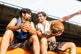 Two causian basketball player resting and ralax.