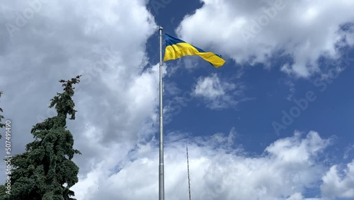The flag of Ukraine is a great national symbol fluttering in the blue sky. Big yellow and blue Ukrainian state flag, Kyiv, Independence Constitution Day, National holiday.