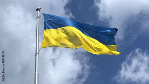The flag of Ukraine is a great national symbol fluttering in the blue sky. Big yellow and blue Ukrainian state flag, Kyiv, Independence Constitution Day, National holiday.