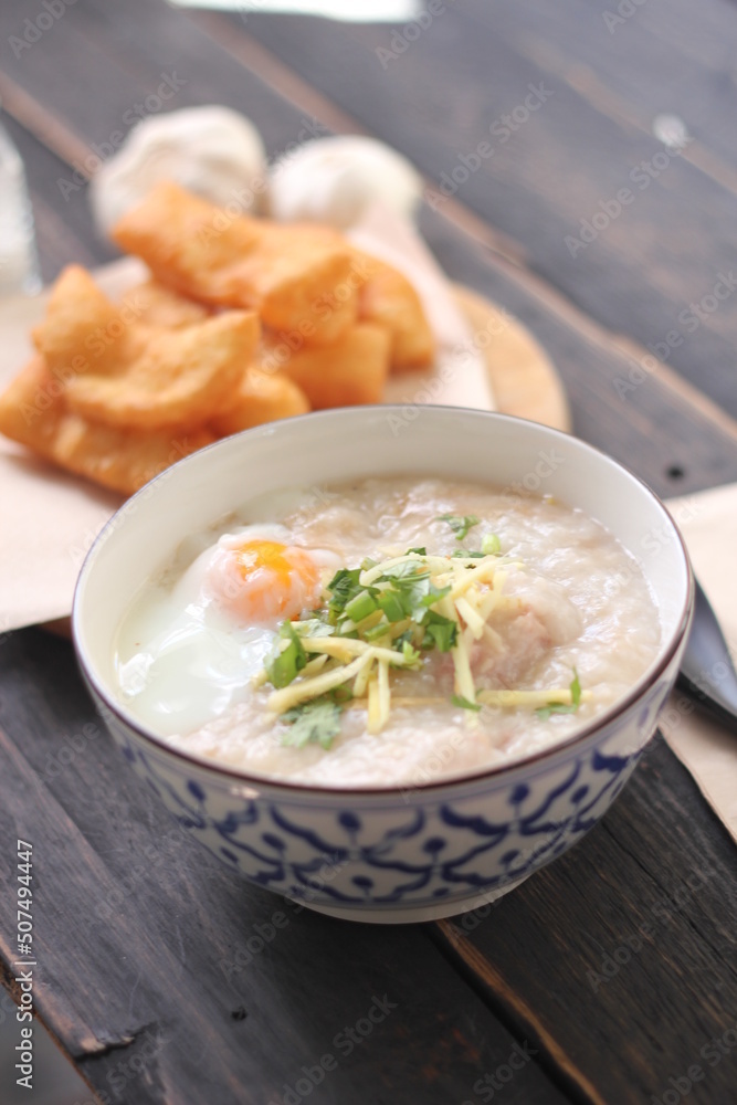 Congee in a Thai-patterned cup and fried dough are Thai food and street food popular to eat in the morning Congee in a Thai-patterned cup and fried dough are Thai food and street food popular to eat in the morning