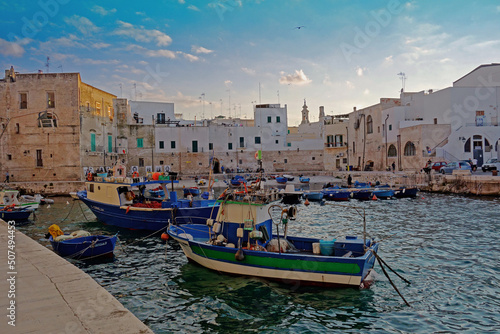 The beautiful picturesque fishing harbour with boats of the charming and typical of the region stonewalled city of Monopoli in Apulia Southern Italy 