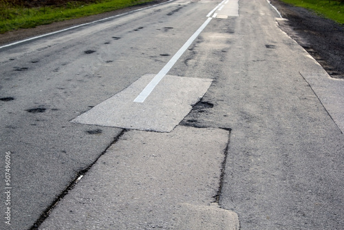 Old repaired asphalt road photo