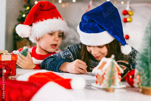 Children write a letter to Santa. Christmas holidays concept.