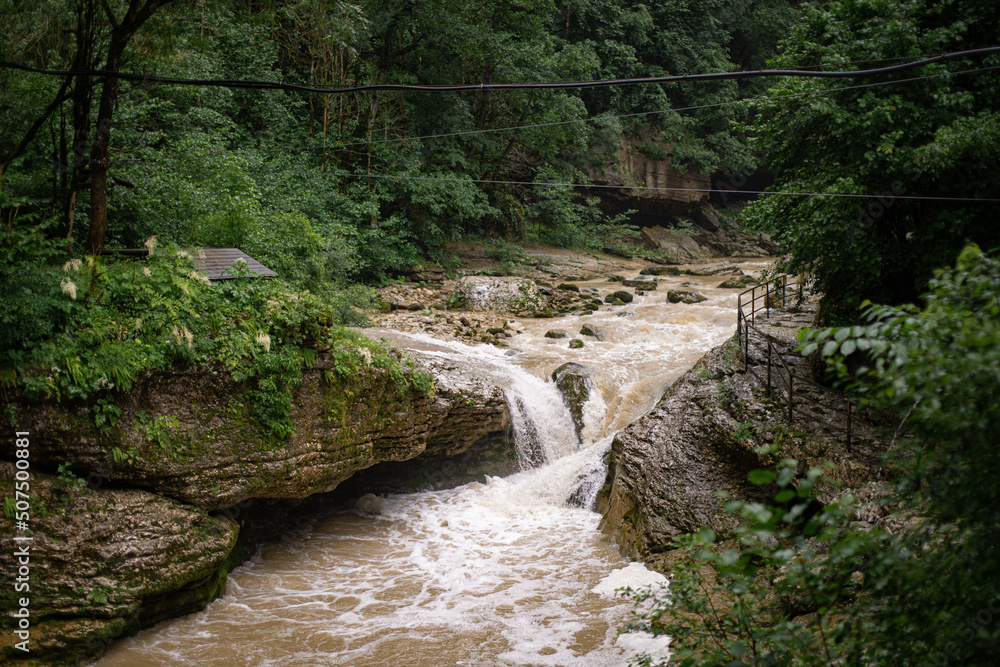 Mountain river after rains close-up. Journey through the forest area along the stream. Summer landscape. Mountain river after rains close-up. Journey through the forest area along the stream. Summer landscape.