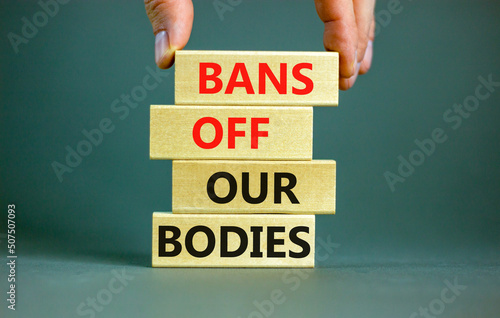 Bans off our bodies symbol. Concept words Bans off our bodies on wooden blocks on a beautiful grey table grey background. Women rights concept. Business social issues and bans off our bodies concept. photo