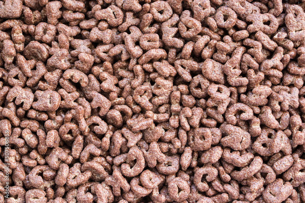 Cereal. Chocolate flakes in the form of letters. Background texture of dry breakfast. Texture. Cereal. Chocolate flakes in the form of letters. Background texture of dry breakfast. Texture.