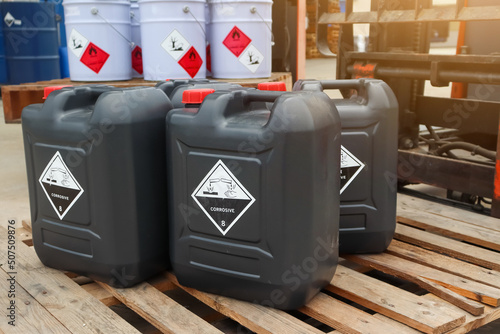 Corrosive chemical symbols on a black chemical tank