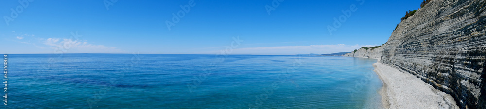 blue sea and sky. Idyllic, picturesque view of the seascape, rocky coast, top view. Good for background. copy space