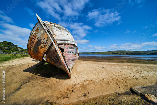 Front of shipwreck on sandy beaches with blue sky