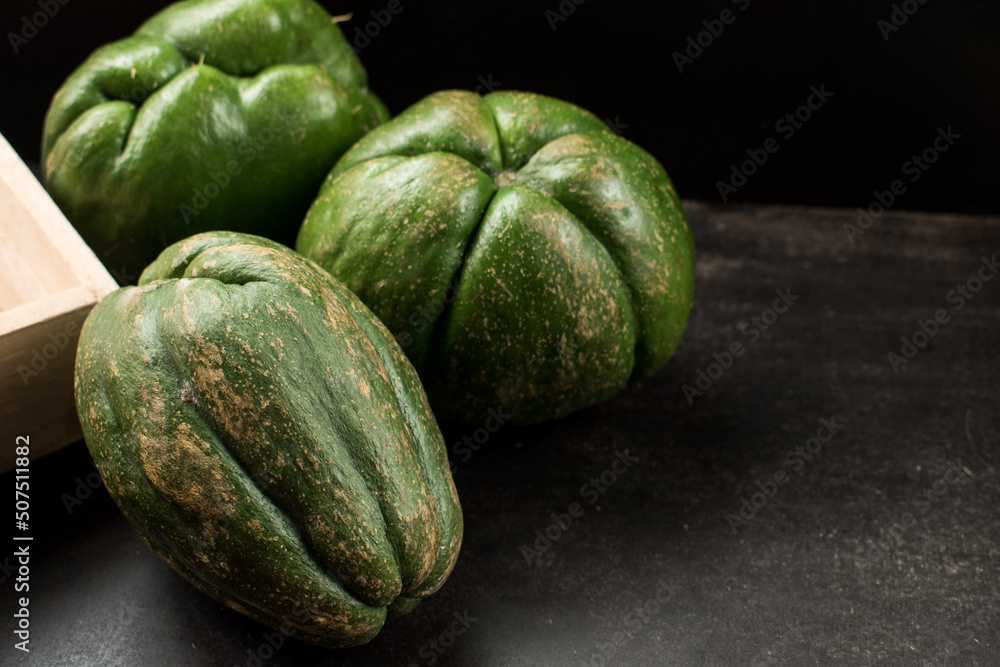 Fresh green traditional latin fruit on black wooden table	