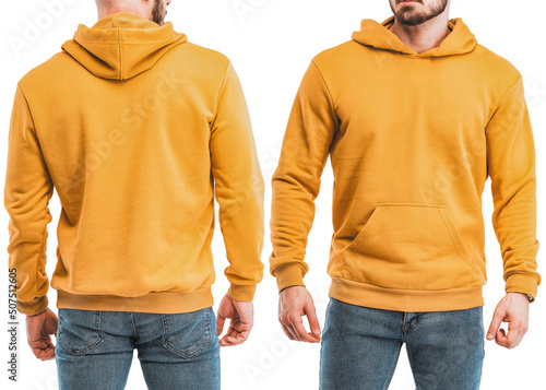 Young man standing in a colorful yellow hoodie mock-up sweatshirt on a man design template. A bearded man wears streetwear. Basic clothing line no logo
