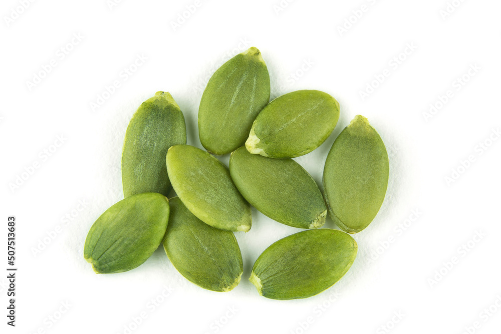 Peeled pumpkin seeds on a white isolated background close-up. Top view. Peeled pumpkin seeds on a white isolated background close-up. Top view.