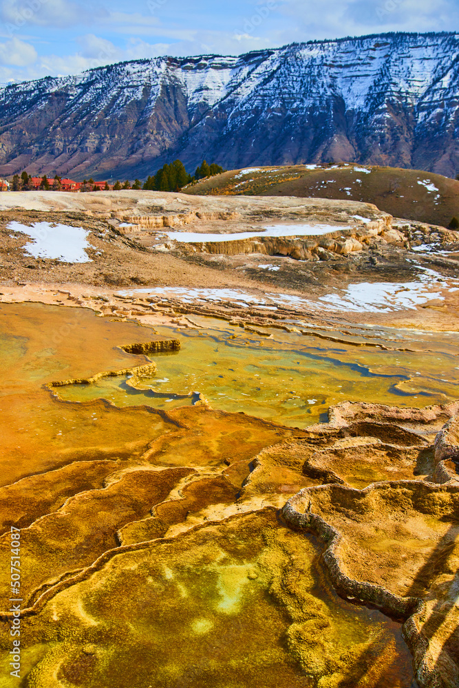Amazing and colorful hot spring terraces with snowy mountains in Yellowstone