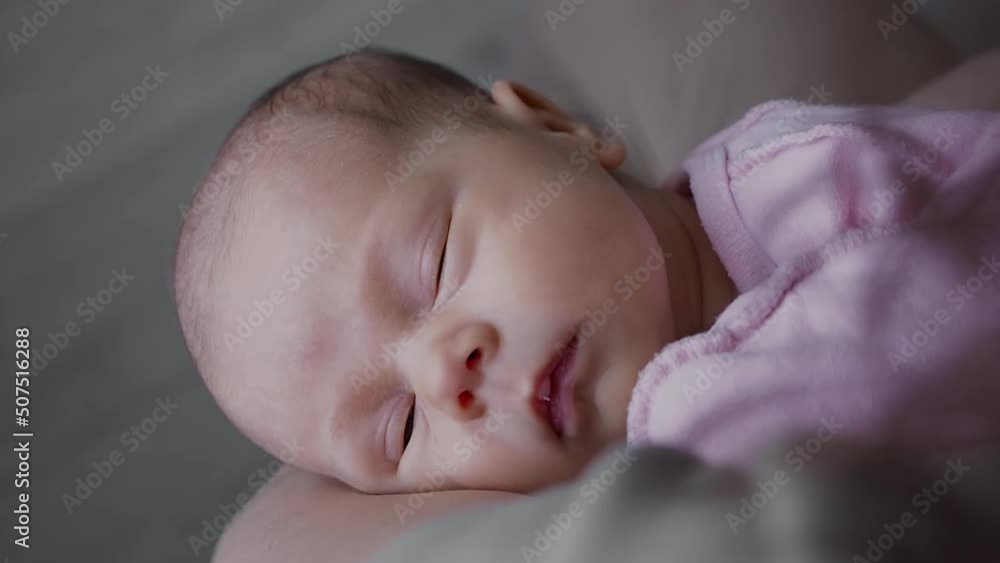 woman holding one month new born in arms at daytime. Baby resting with mother. woman holding one month new born in arms at daytime. Baby resting with mother.