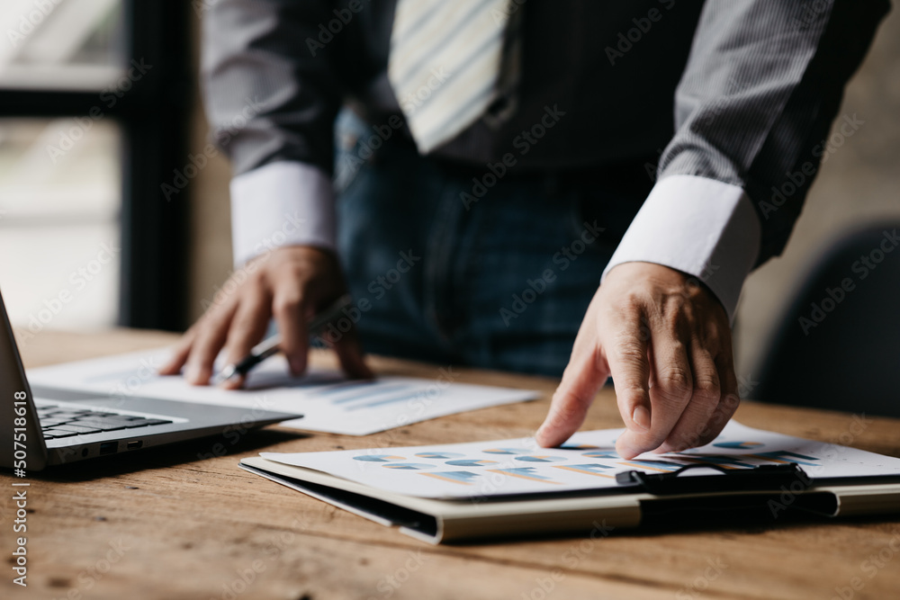 Businessman sits in a private office at his company and is reviewing company financial documents, senior management checking financial information for accuracy. Financial management. copy space Businessman sits in a private office at his company and is reviewing company financial documents, senior management checking financial information for accuracy. Financial management. copy space
