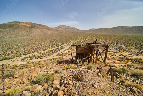 Desert of Death Valley with broken mining equipment by mine photo