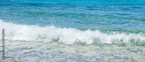 Sea wave close-up. Splashes of water on the sea surface. Summer vacation at the seaside