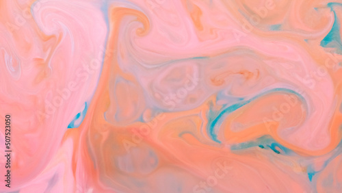 Peach coral color background. Fluid art texture with coral color. Abstract background with multicolored spots on liquid