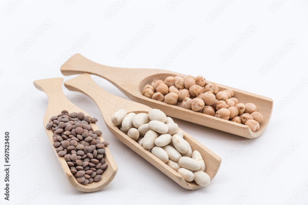 three wooden pallets with different legumes on a white background three wooden pallets with different legumes on a white background