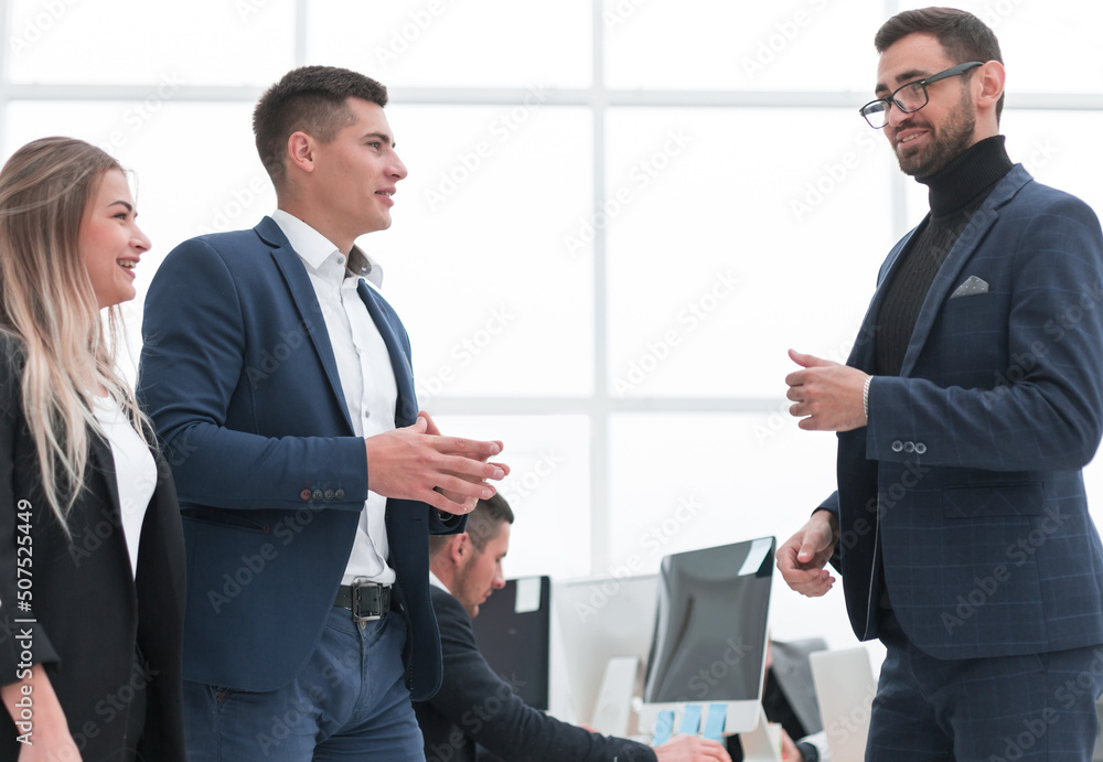 business team discussing work issues standing in the office business team discussing work issues standing in the office