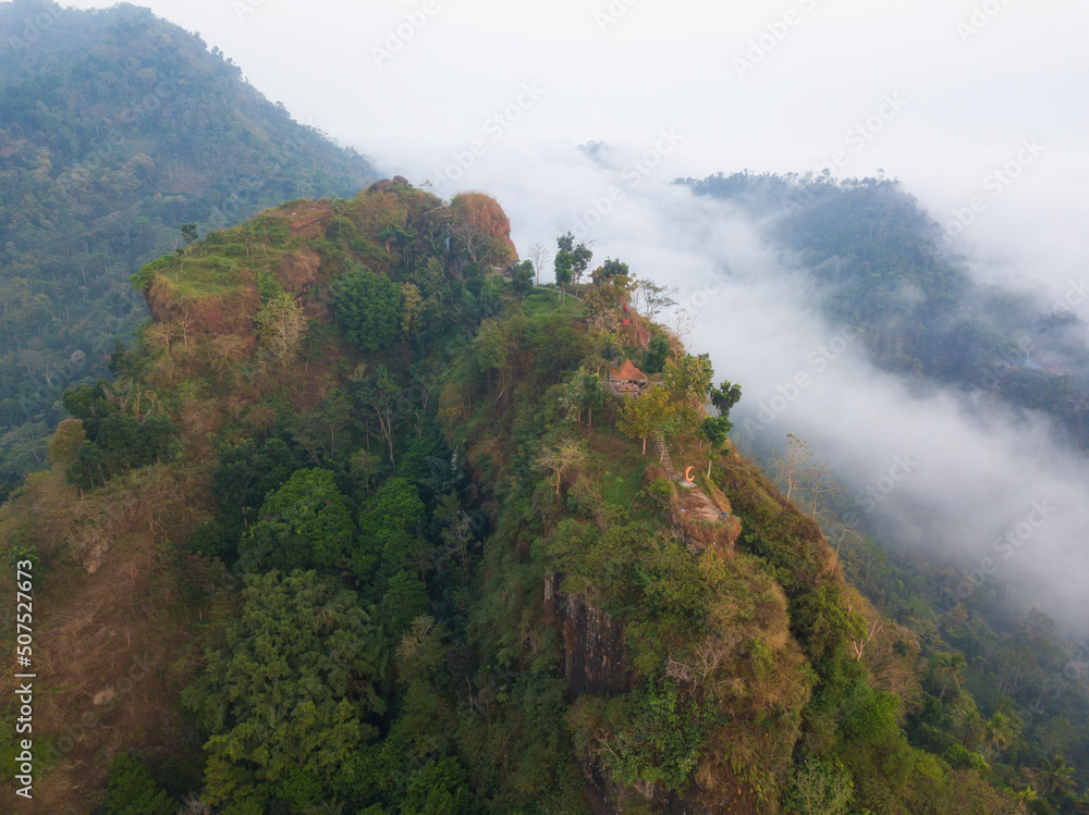 Hill which overgrown with dense of trees in the morning  with misty condition weather. The hill named Menoreh Hill, Central Java, Indonesia