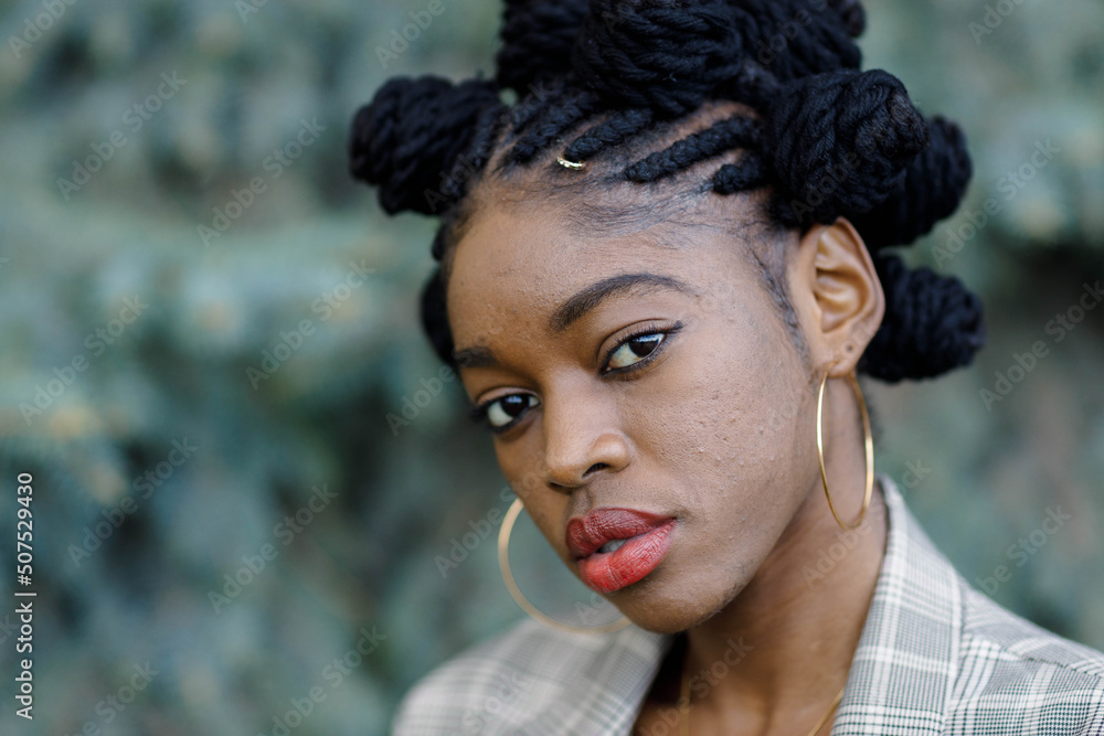 african girl on the background of a blue spruce african girl on the background of a blue spruce