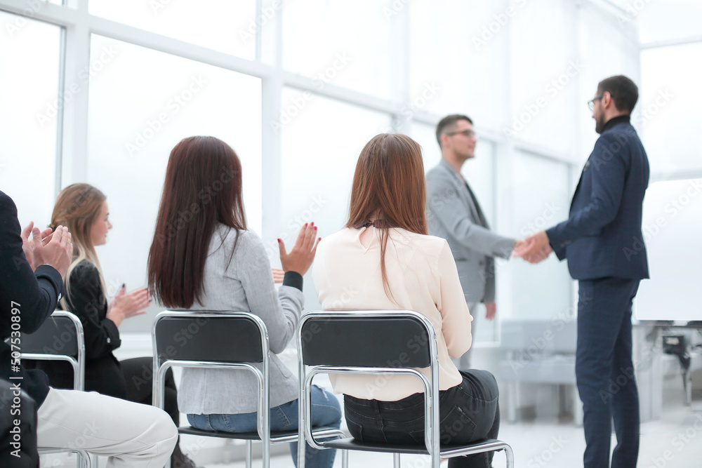 project Manager and business team congratulating the best employee. project Manager and business team congratulating the best employee.