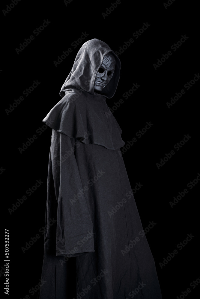 Vampire with cape showing his scary teeth isolated on black background Vampire with cape showing his scary teeth isolated on black background