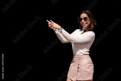 .Casual young woman on black background. advertising space