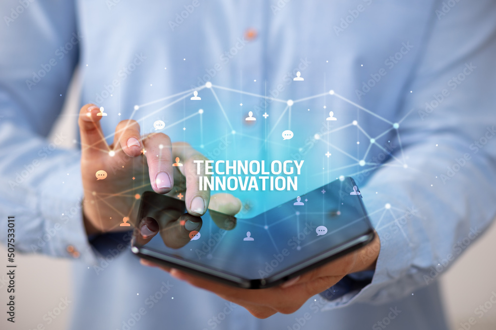 Businessman holding a foldable smartphone, new technology concept Businessman holding a foldable smartphone, new technology concept