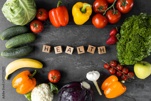Fototapeta Naklejka Na Ścianę i Meble -  Organic vegetables and fruits. Text Health on Wooden cube