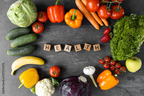 Organic vegetables and fruits. Text Health on Wooden cube