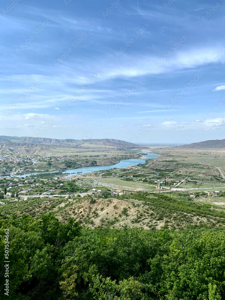 Landscape of the Sulak river valley in the Sulak canyon. valley with buildings and high-voltage power poles that go from the Chirkeyskaya hydroelectric power station, Dagestan