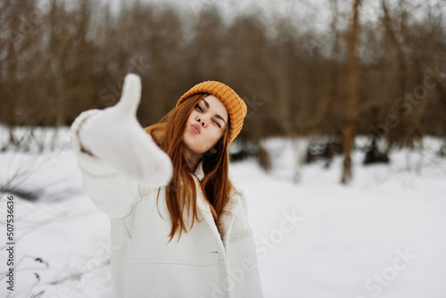 young woman red hair walk in the fresh winter air There is a lot of snow around
