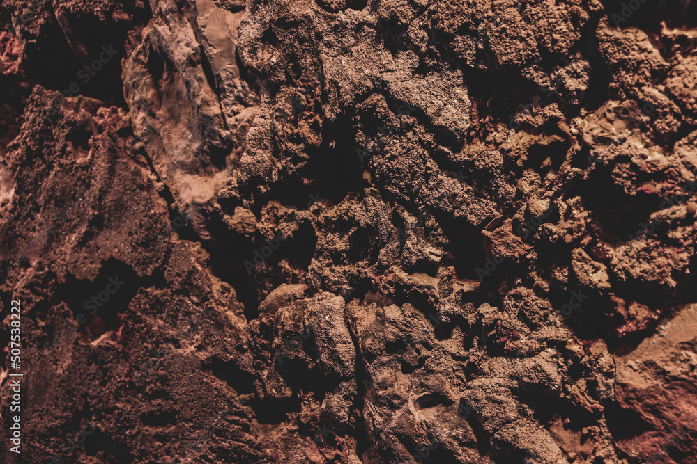 Fototapeta premium Brown wall texture. Stone background. Rock texture. Grunge Rough structure. Abstract texture. Rock surface with cracks. Rock pile. Paint spots.