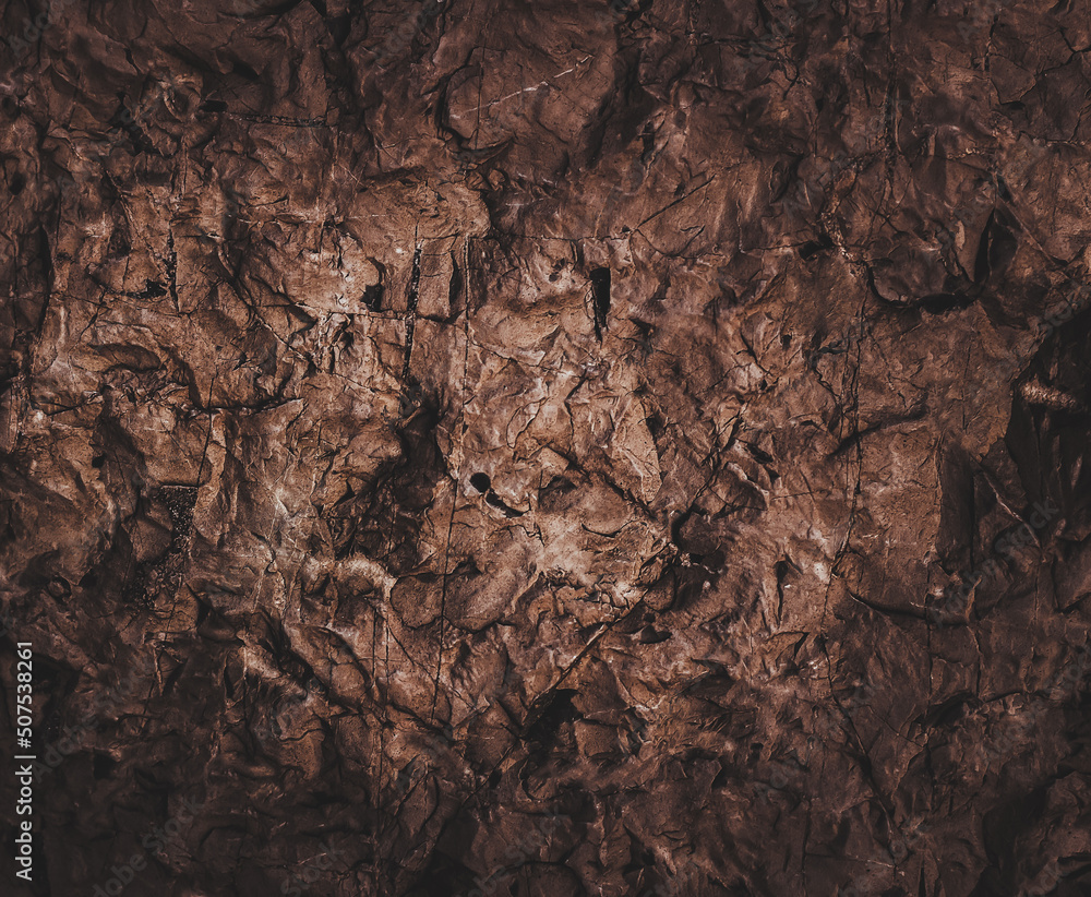 Brown wall texture. Stone background. Rock texture. Grunge Rough structure. Abstract texture. Rock surface with cracks. Rock pile. Paint spots. Brown wall texture. Stone background. Rock texture. Grunge Rough structure. Abstract texture. Rock surface with cracks. Rock pile. Paint spots.