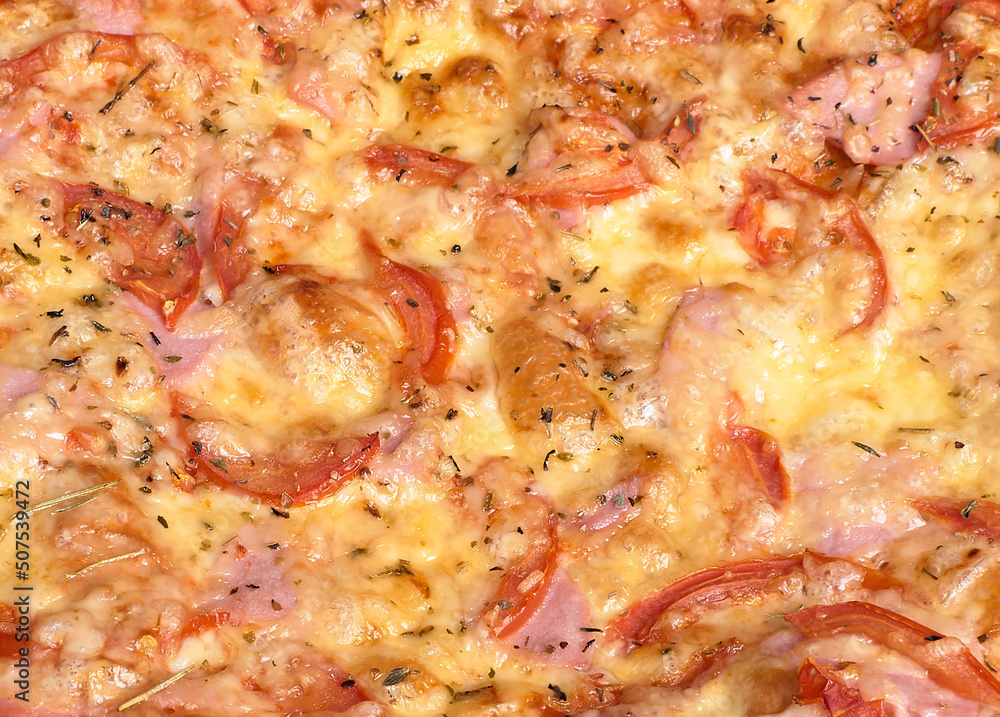 pizza with melted cheese, peppers, tomatoes and ham close-up pizza with melted cheese, peppers, tomatoes and ham close-up