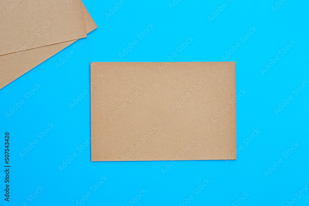 Brown paper with clip on blue background. Brown paper with clip on blue background.